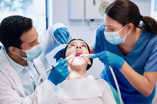 dentist-team-patient-cleaning-mouth